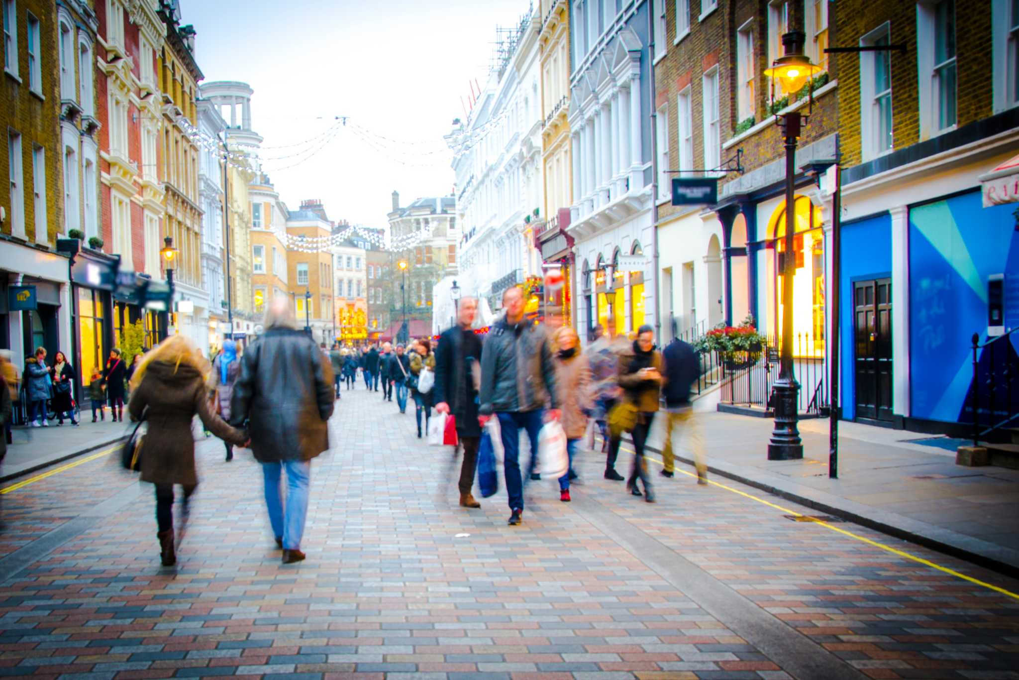 A group of people walking down a street.
