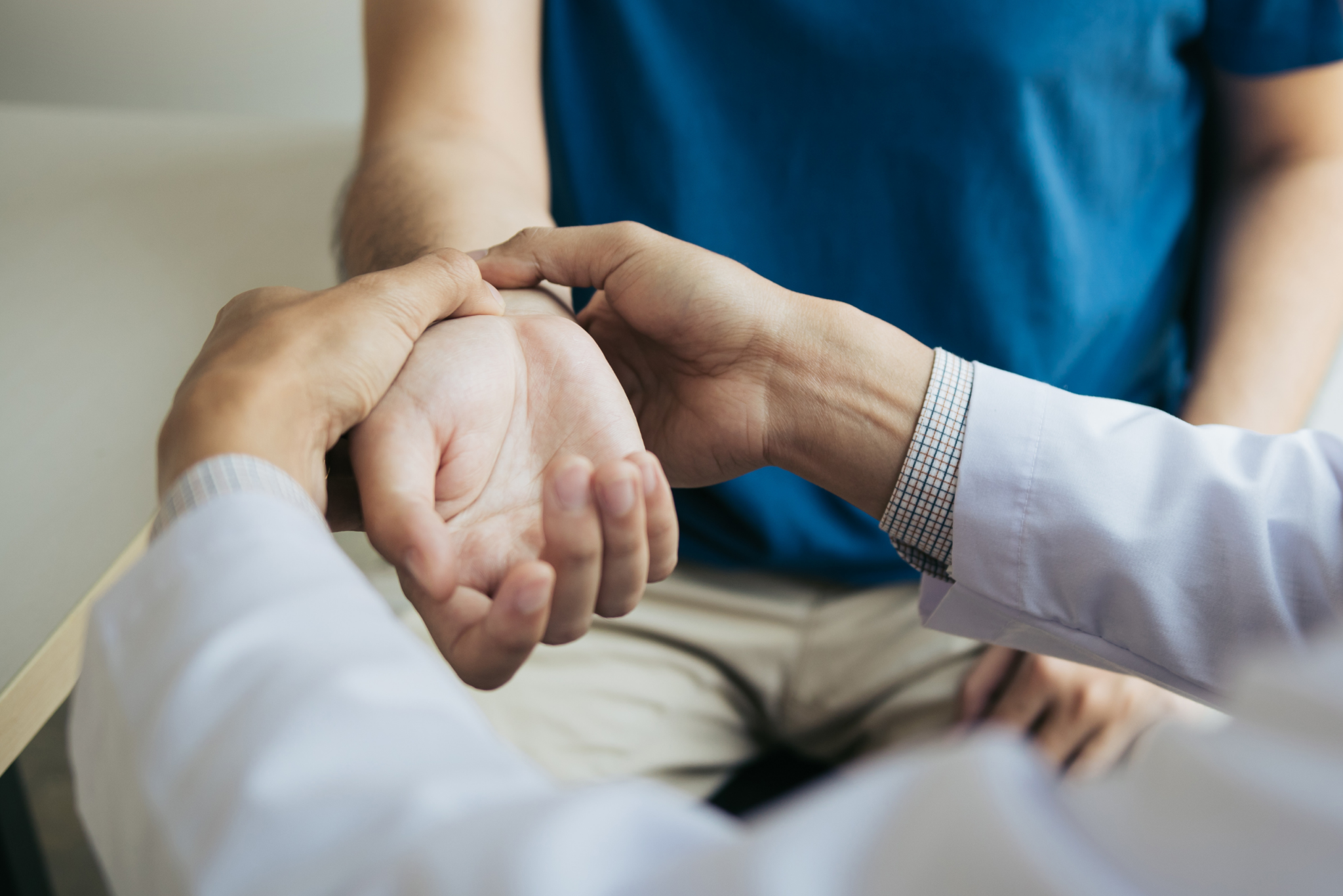 A doctor is examining a patient's wrist.