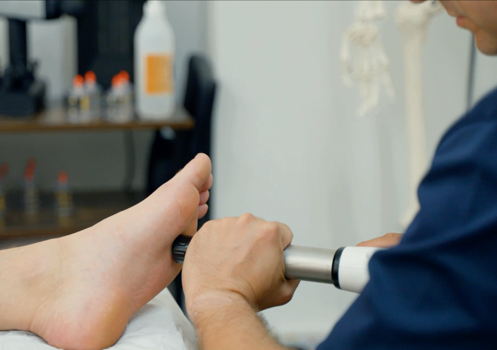 A person getting a foot massage in a doctor's office.